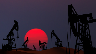 oil pumps at sunset in front of a reddish sun