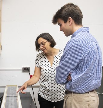 Two people looking at lab equipment in a lab