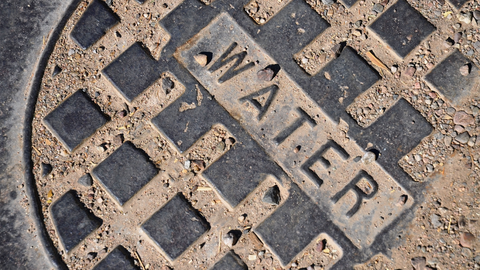 Water main cover on a street surface