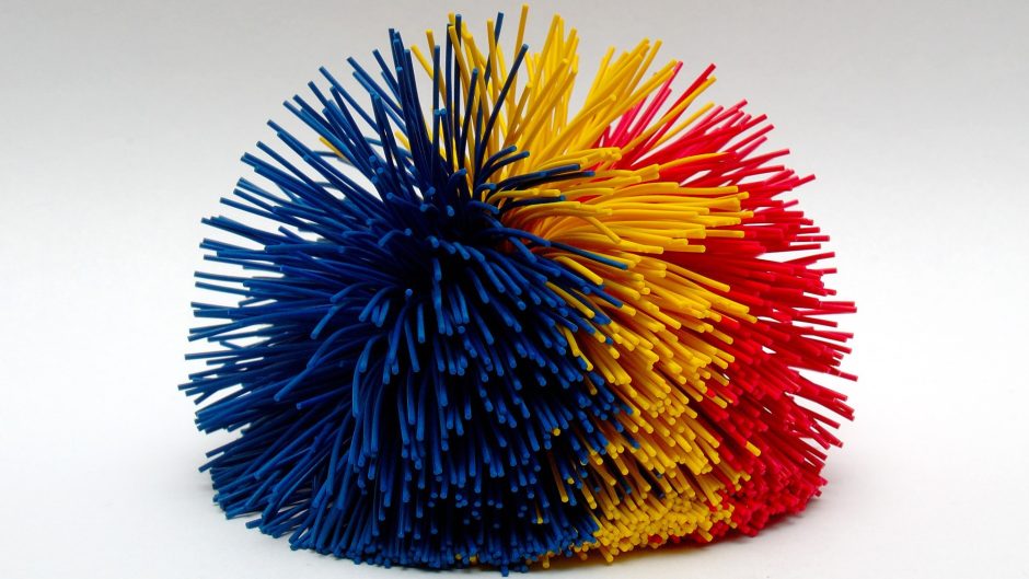 Picture of a koosh ball that has blue, yellow and red strands
