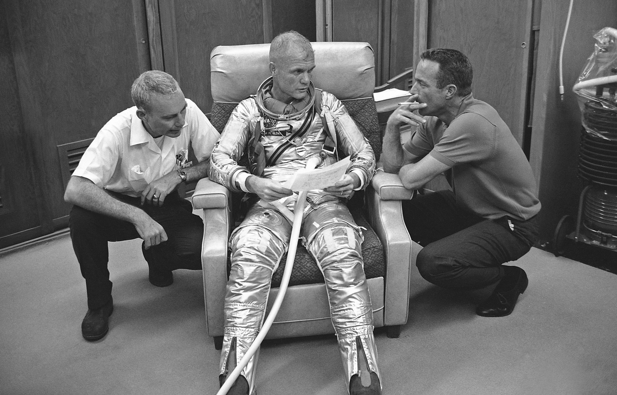 men talking with astronaut