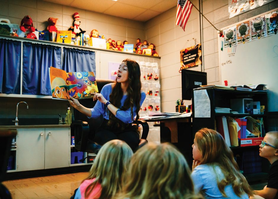 student teacher reading to children