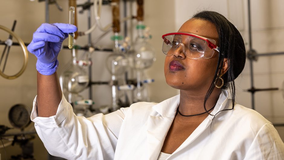 Doctoral Student Faith Aynekulu in a chemistry building lab