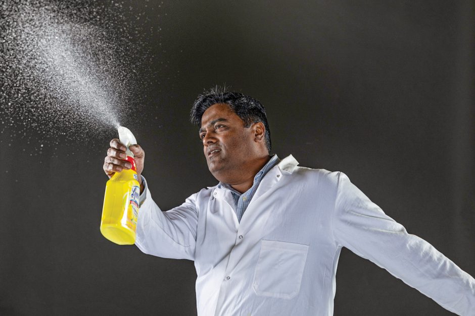 man spraying kitchen cleaner