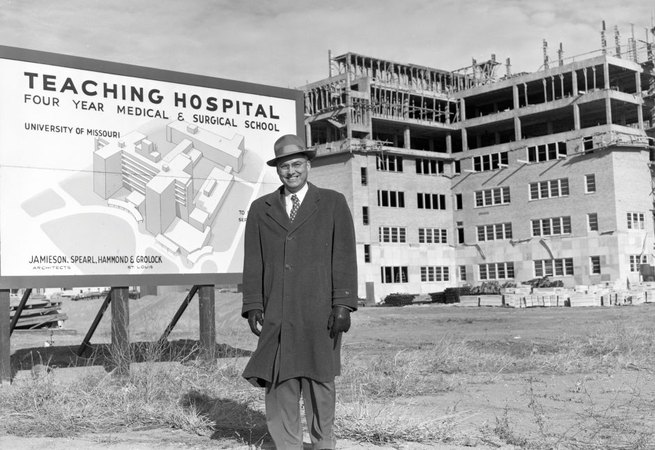 man standing by university hospital construction