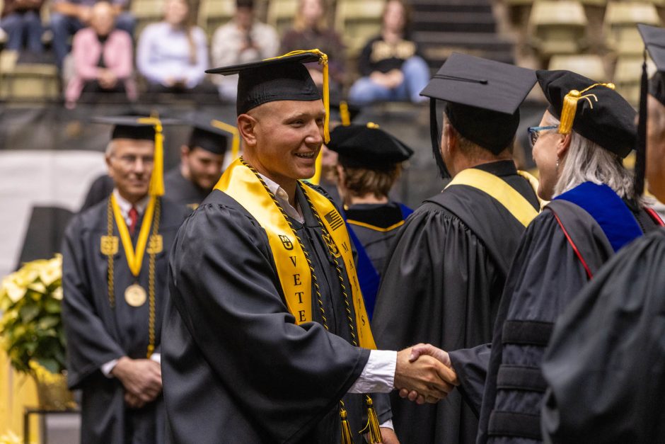 a graduate shaking hands