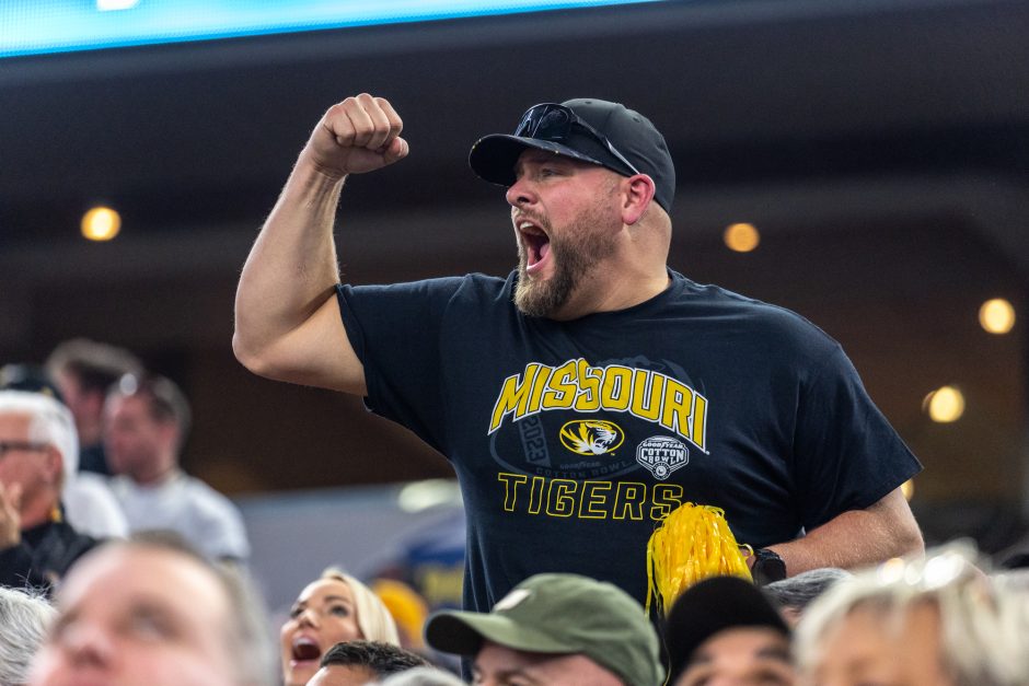 A fan cheers at the Cotton Bowl at AT&T Stadium.