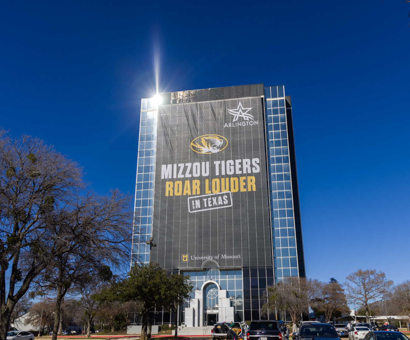 Large wrap around Copeland Building in Arlington, Texas, that says Mizzou Tigers Roar Louder in Texas.
