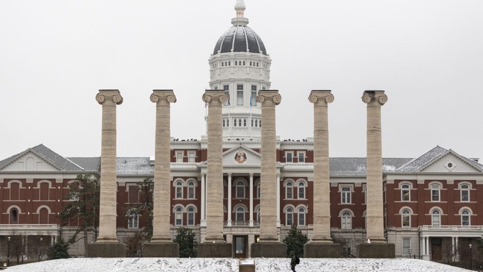 picture of the columns at the University of Missouri with Jesse Hall in the background and snow on the ground
