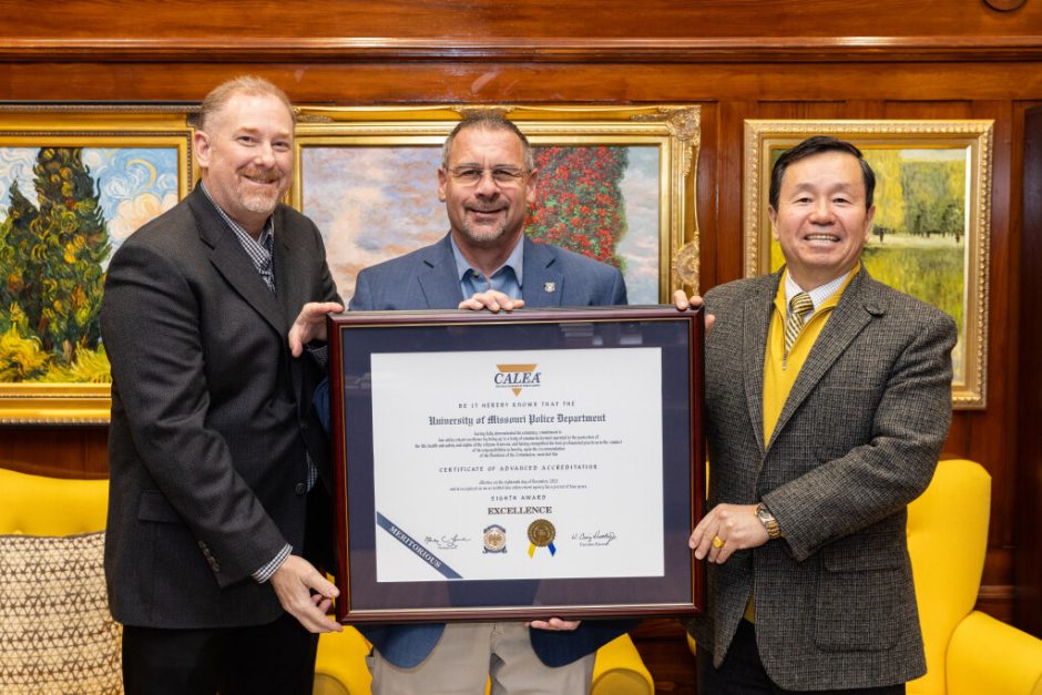 Sergeant Dennis Stroer and Chief Brian Weimer of the MUPD are presented with the CALEA reaccreditation award by President Choi.