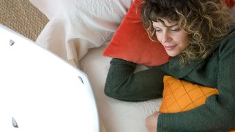 a woman in bed using light therapy