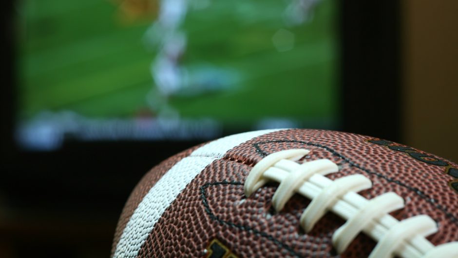 Football in front of a television