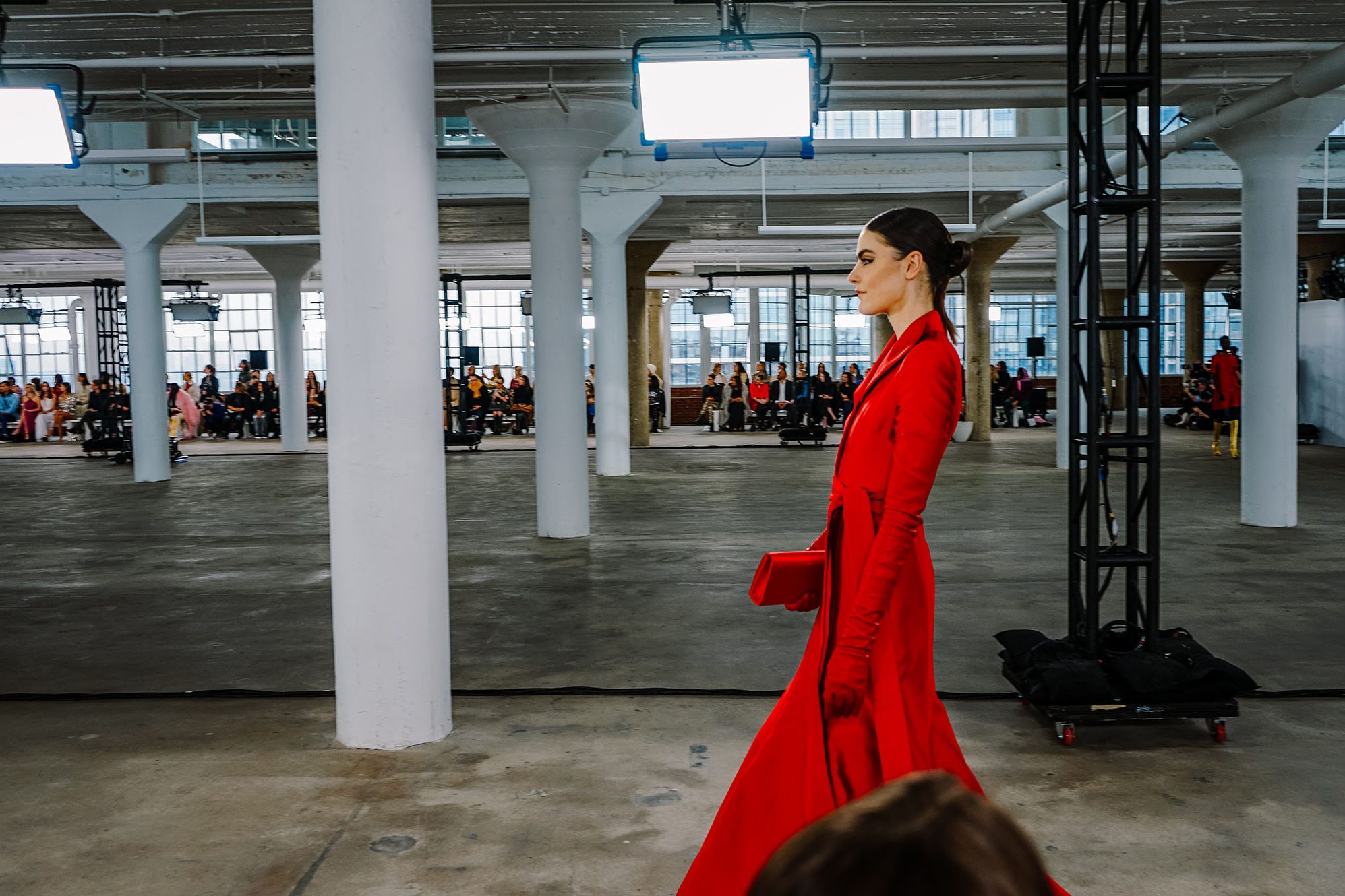 a woman in red walks the runway