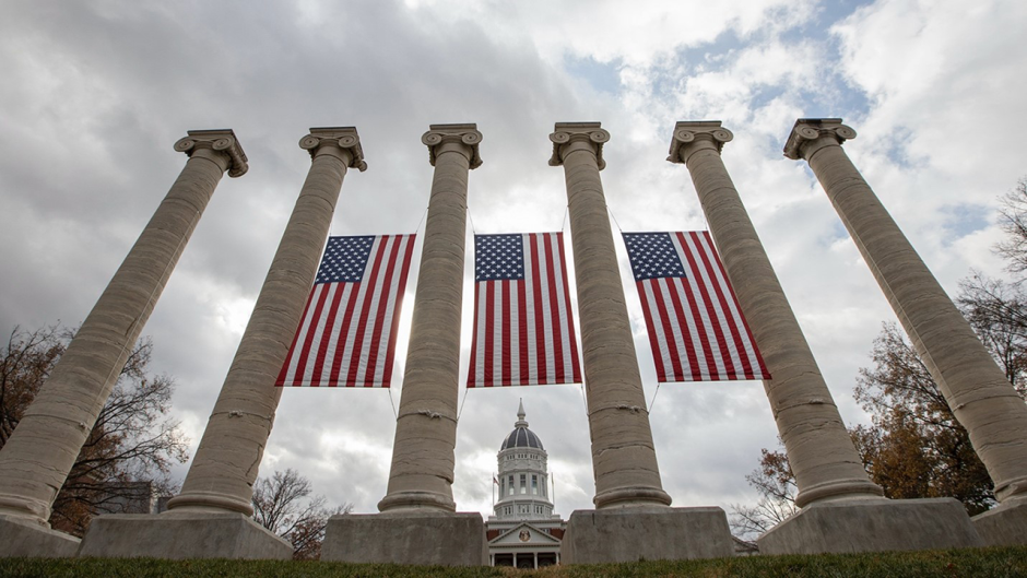 MU's columns with American flags hanging from them.