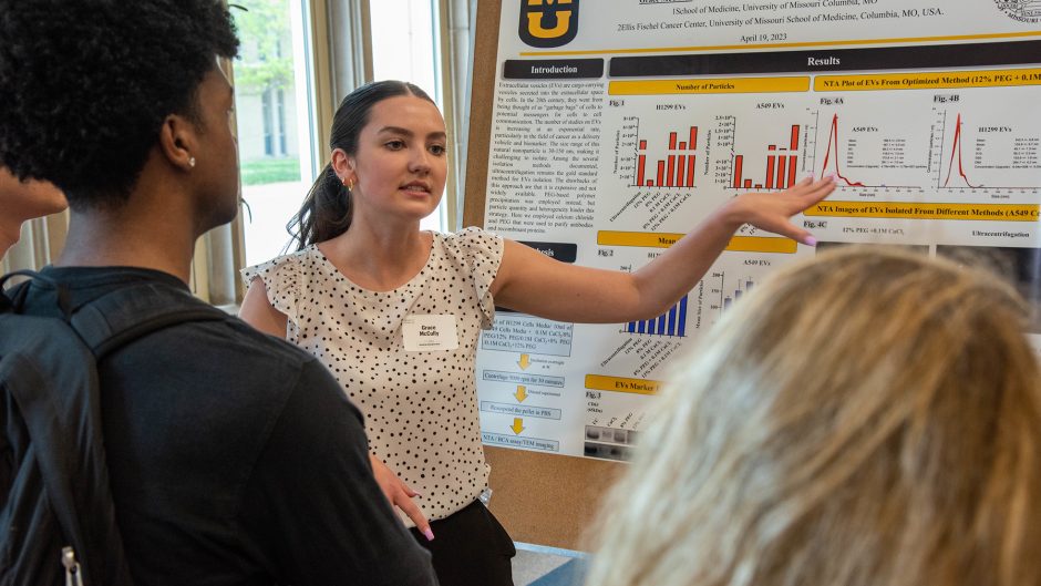 grace mccully presents her poster at show me research week