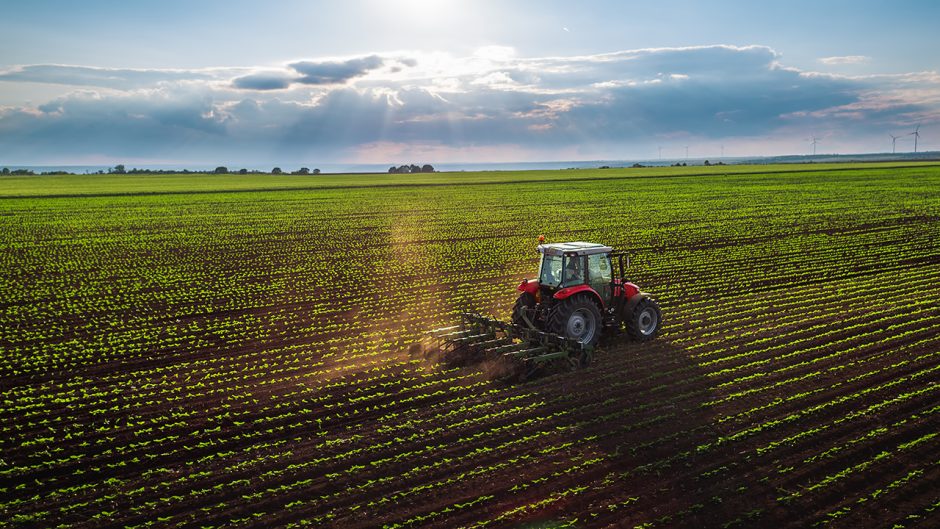 tractor working on a field of crops
