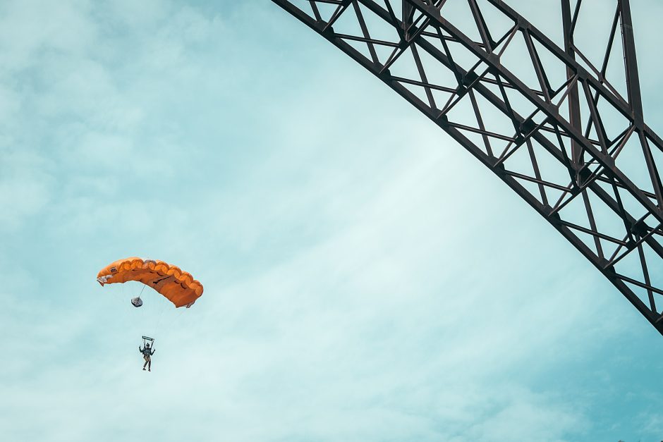 parachuter descending from bridge