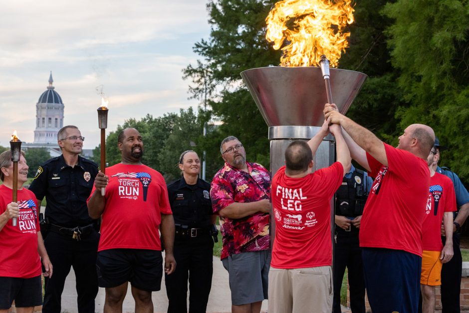 Special Olympics participants light the torch