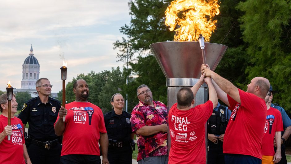Special Olympics participants light torch