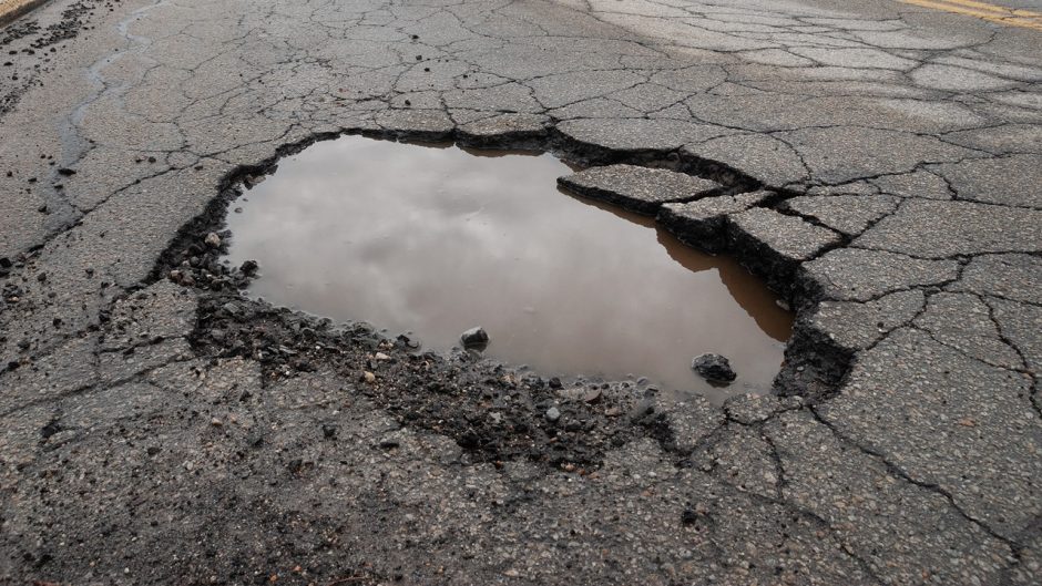 a pothole filled with water on a road
