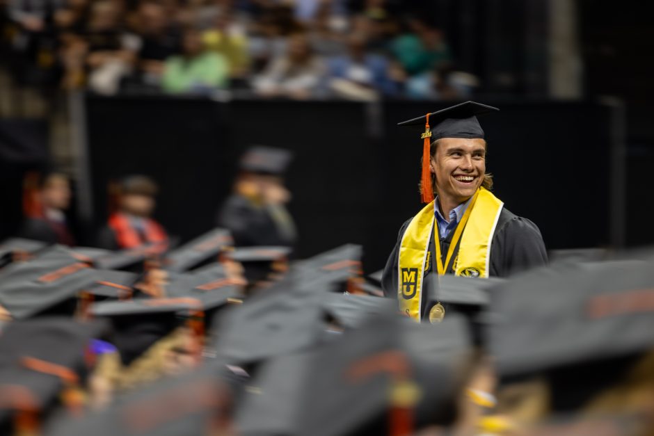 Graduate stands among crowd