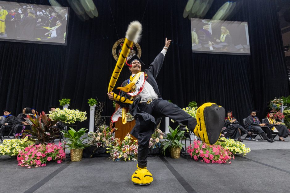 Graduate wears Truman mascot feet and tail