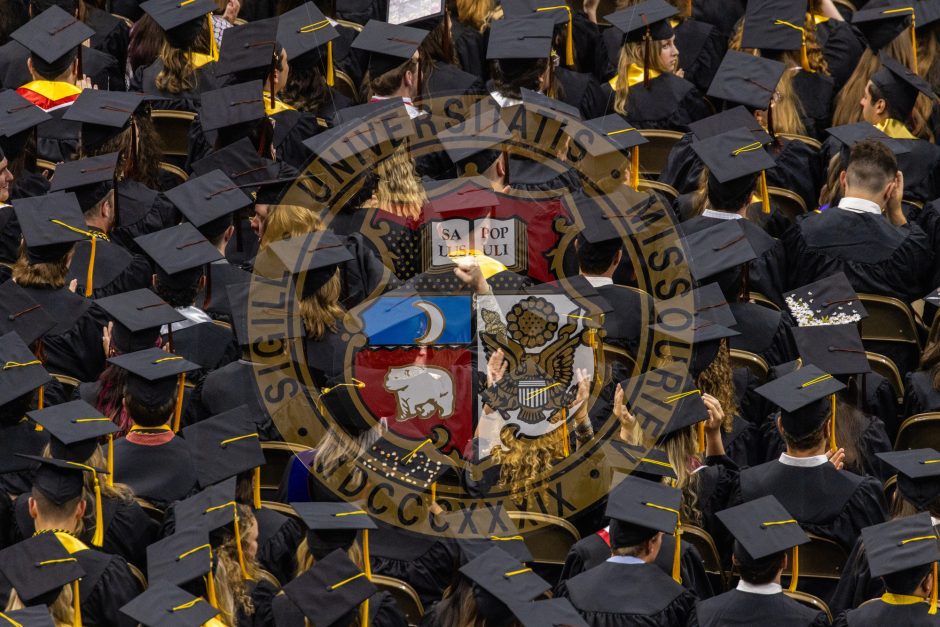 University seal with graduates behind it