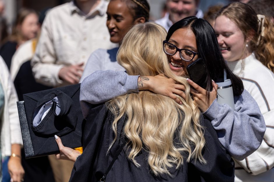 Graduate hugs loved one