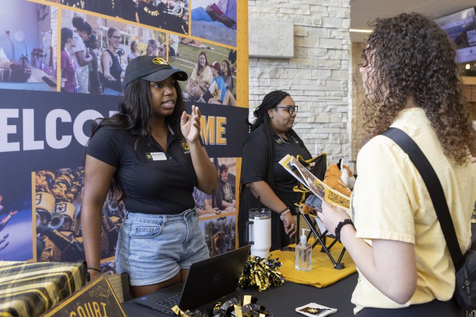 Students check in for Summer Welcome at the table.