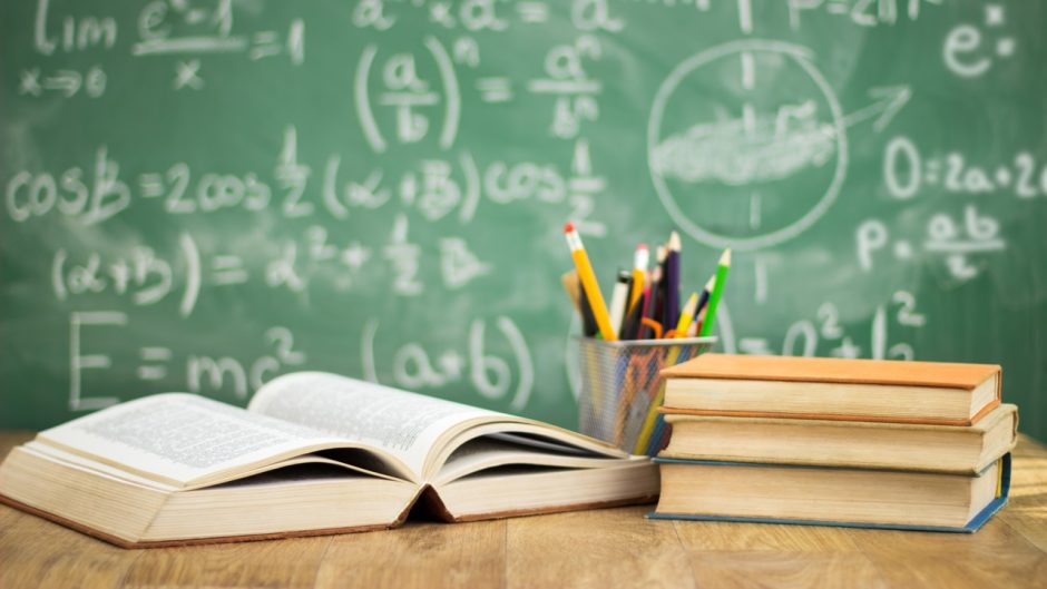 School books on desk, education concept