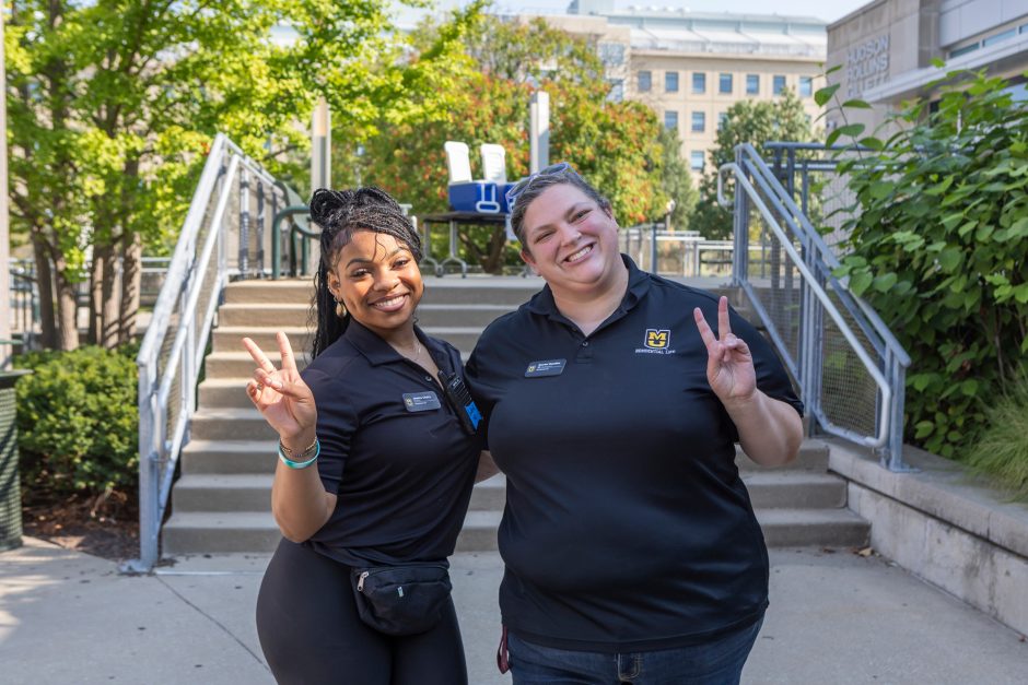 Two students smiling at camera