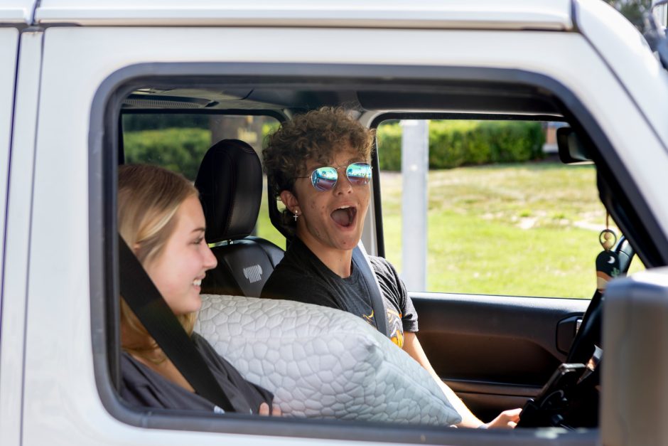 Student in car smiles