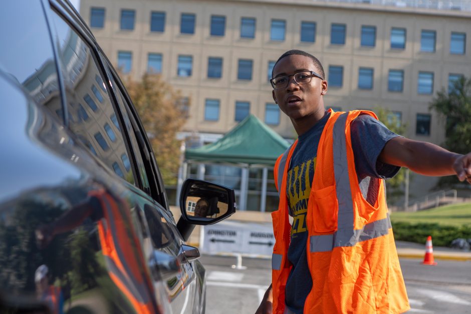 Move-in volunteer directs cars