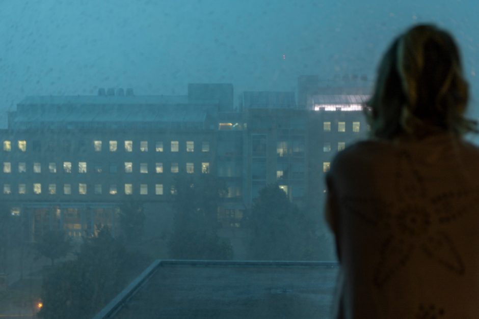 Student looks out window at rain