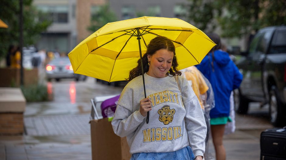 Student with yellow umbrella