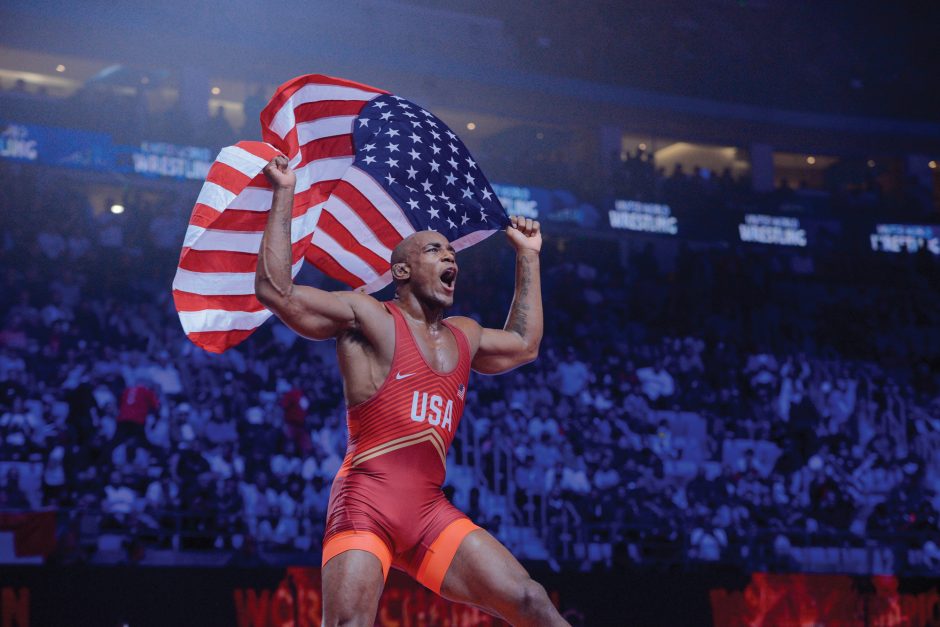 J'den Cox raising American flag