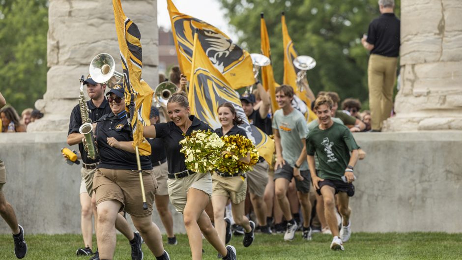 Students run through the columns during Tiger Walk event