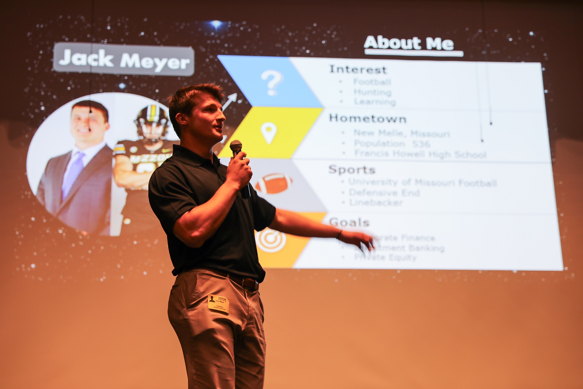 a person presenting in front of a projector screen