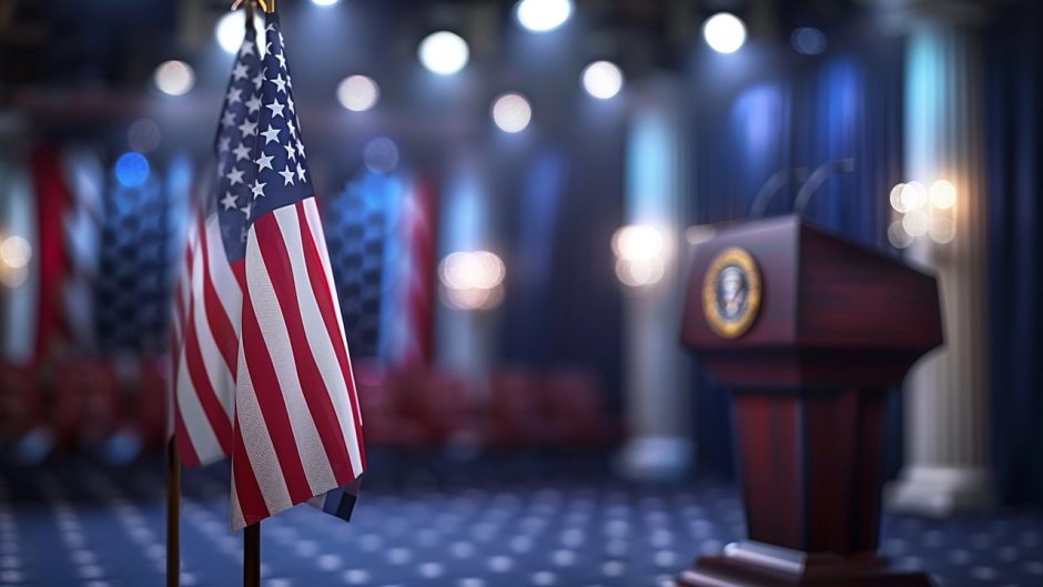 A symbolic shot of the 2024 presidential candidate at a podium, with the American flag serving as a backdrop