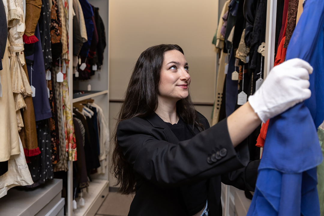 A student looking at historical clothes.