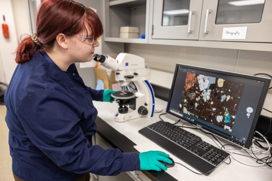 Student looks at sample on computer screen in the Archaeometry Laboratory