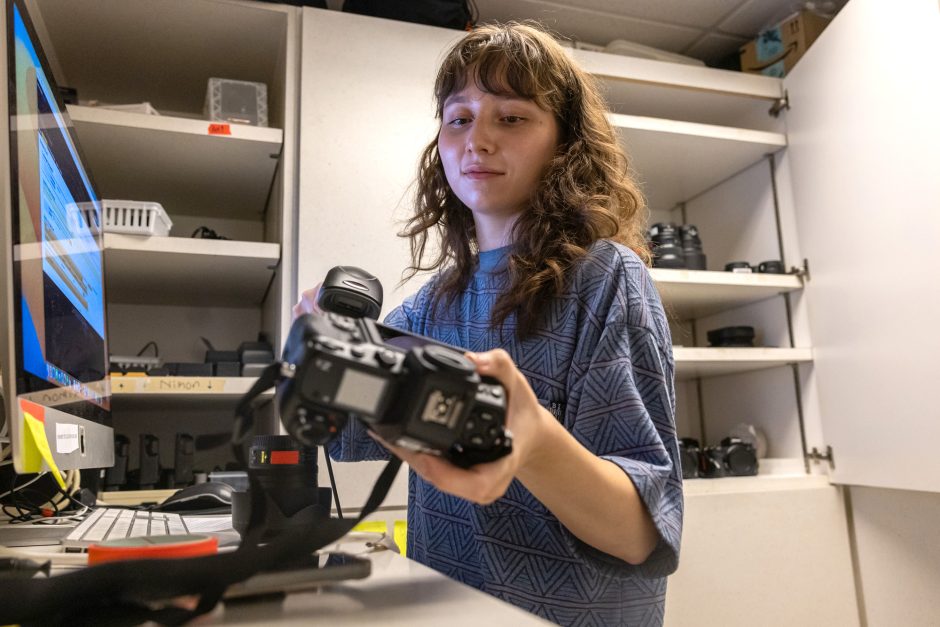 Student holds mirrorless camera