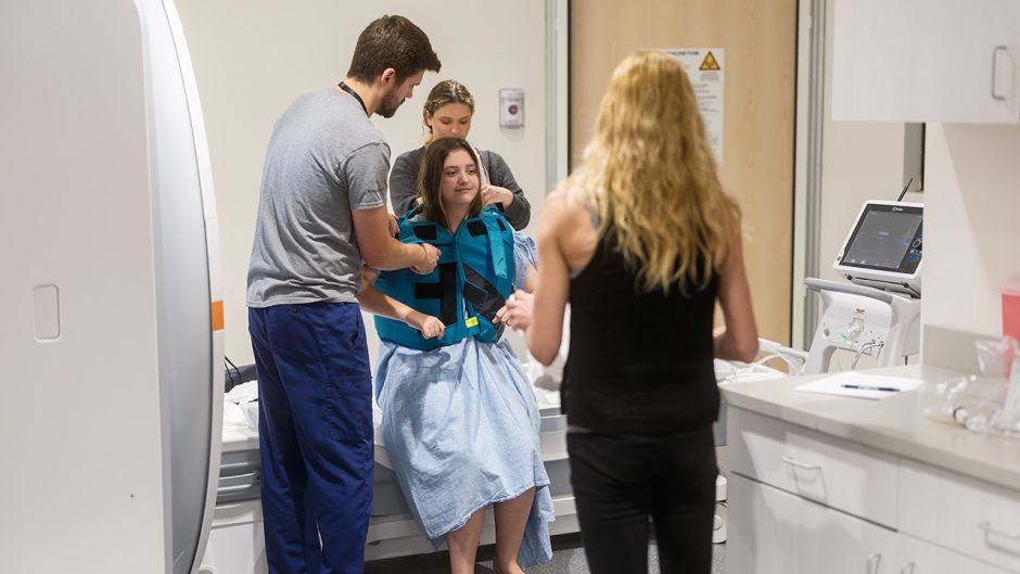 Hannah Gryder surrounded by a medical team.