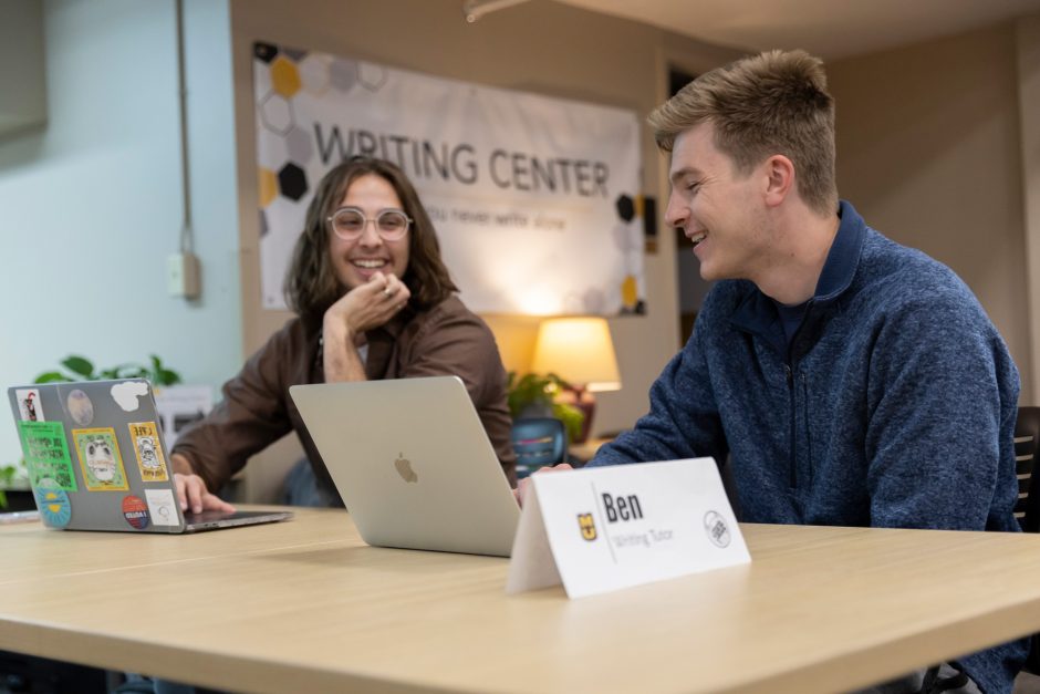 Two students with laptops at Writing Center