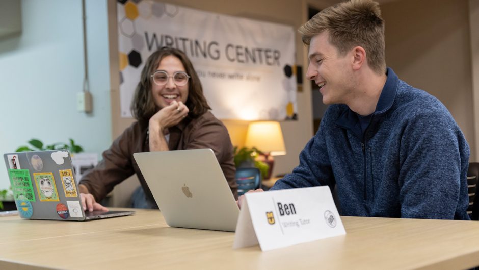 Two people with laptops at Student Center