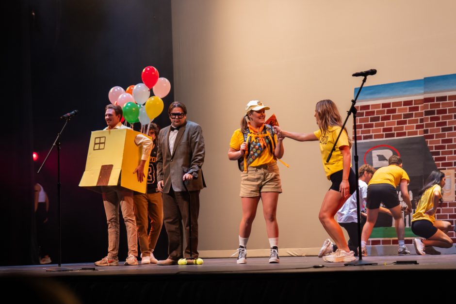 Students perform with balloons and props