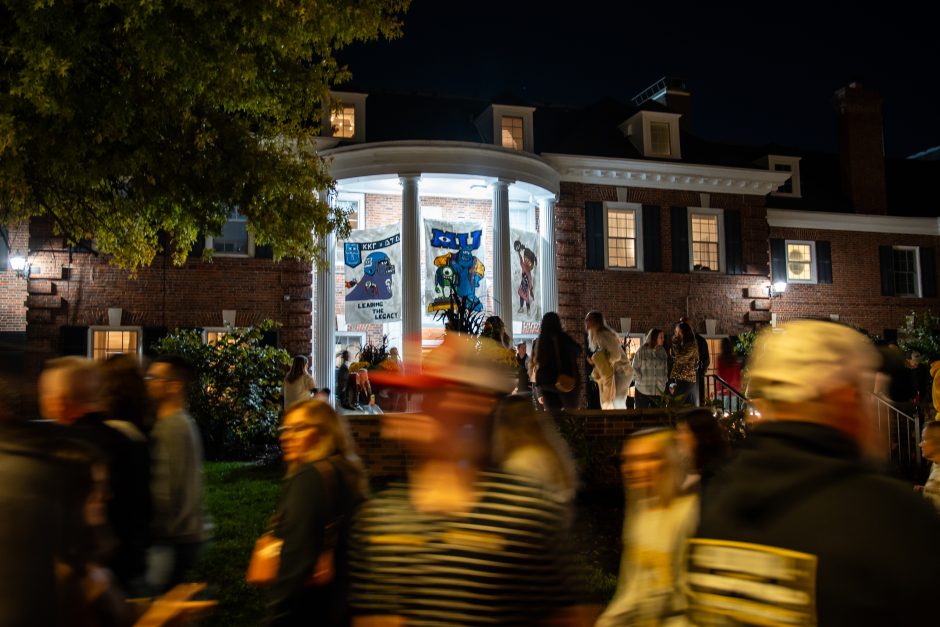 Crowd walks around campus decorations