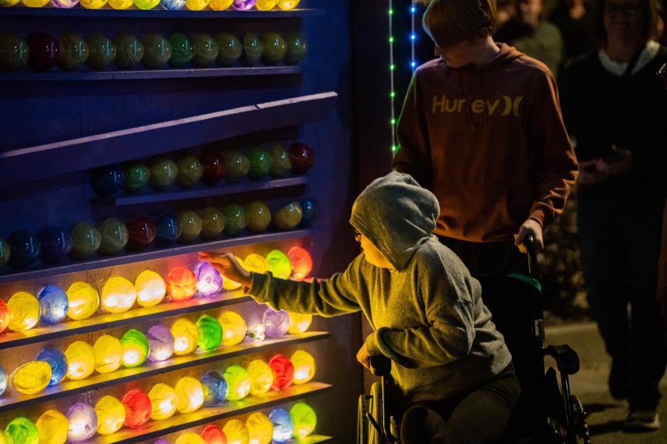 Two people look at colorful lights