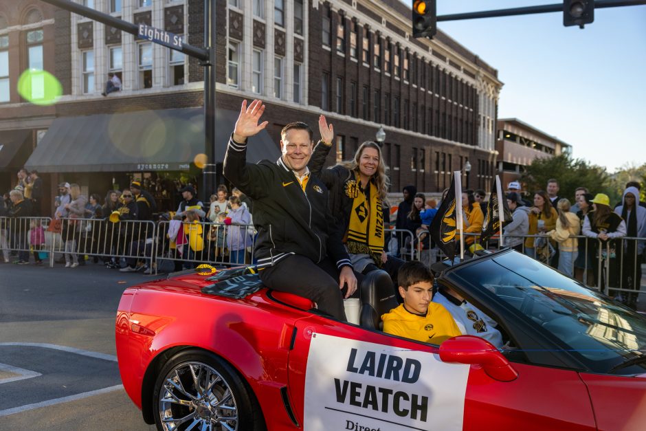 Laird Veatch in a red car at parade