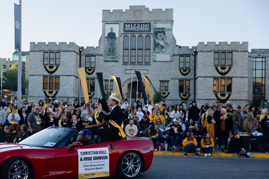 Crowd in front of Mizzou building with Homecoming signage